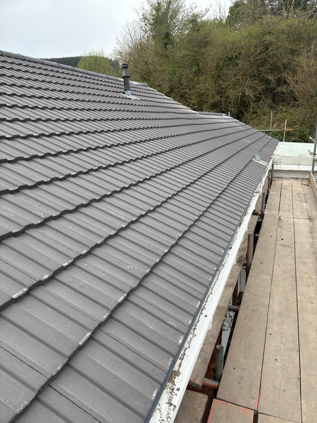 Large new grey tiled roof with new fascias and guttering in Heolgerrig, Merthyr Tydfil