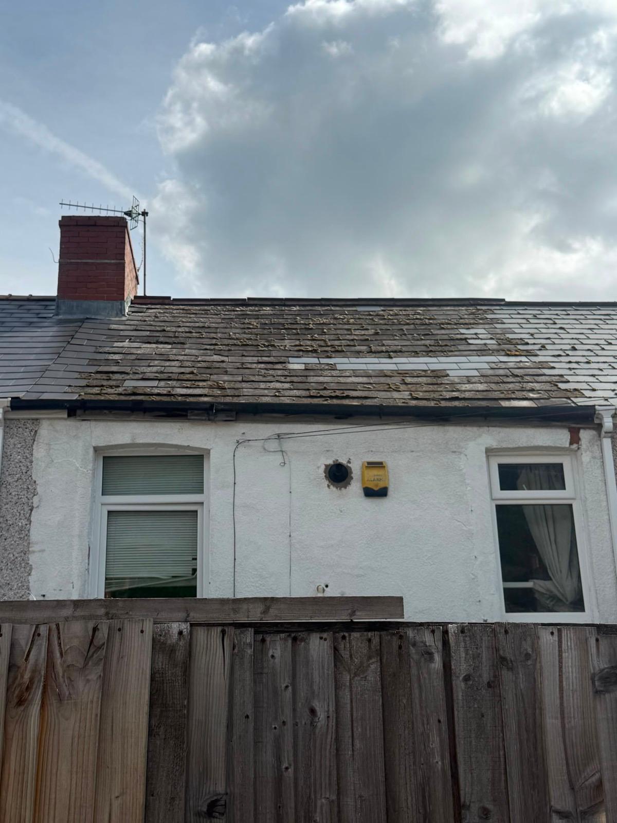 Worn slate roof with slipped and delaminating slates before replacement in Ebbw Vale